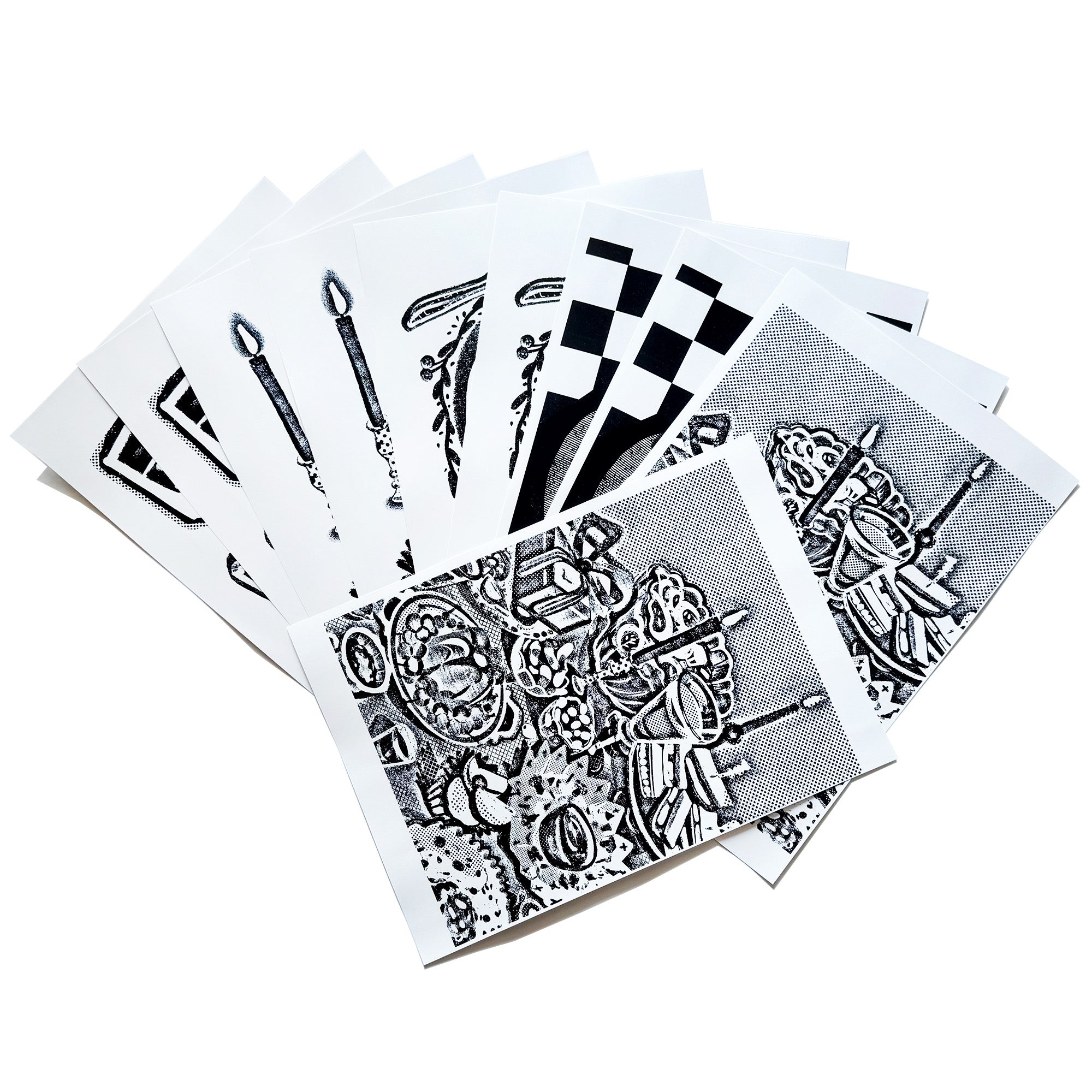 A spread out image of the A4 sized image transfer sheets on the table, showing snippets of the patterns inside.