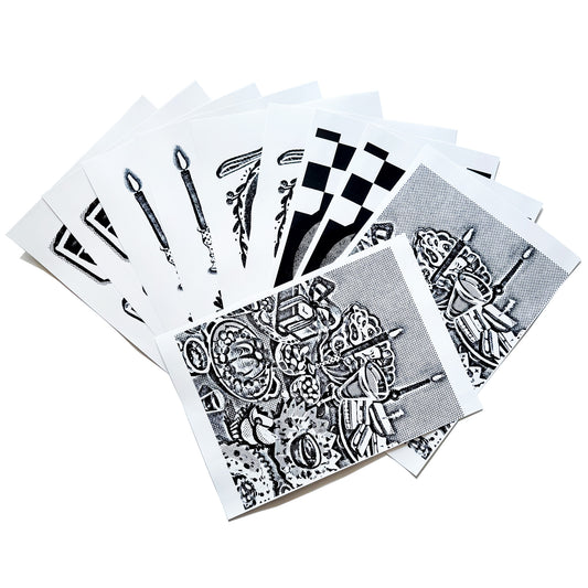 A spread out image of the A4 sized image transfer sheets on the table, showing snippets of the patterns inside.