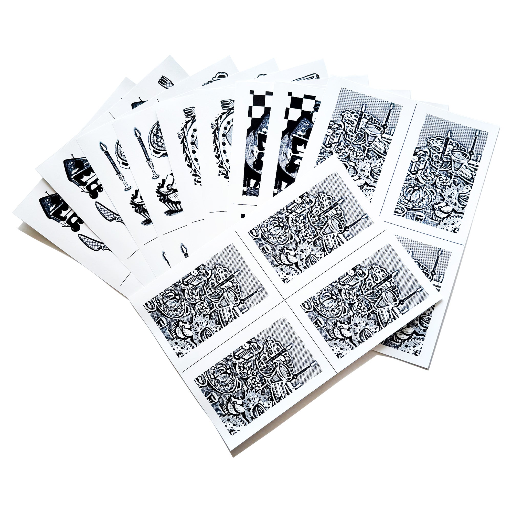 A spread out image of the A6-sized image transfer sheets on the table, showing snippets of the patterns inside.